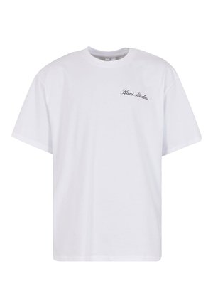 White cotton t-shirt with a relaxed fit, crew neckline, short sleeves, and black "Kani Studios" text embroidered on the left chest.