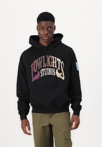 Black hoodie featuring multicolored embroidered text "LOWLIGHTS STUDIOS." Includes a front pocket and a patch on the left sleeve.