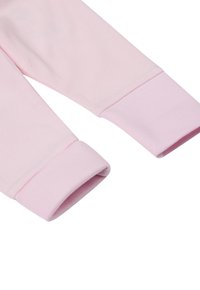 Langärmliges Hemd aus hellrosa Baumwolle mit gerippten Ärmeln. Der Stoff sieht weich aus und die umgeschlagenen Ärmelsäume sorgen für Komfort und Passform.