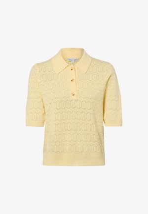 Polo en maille jaune clair à manches courtes avec motif œillet géométrique, trois boutons et col, poignets et ourlet côtelés.