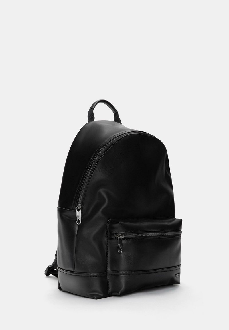 black leather backpack pull and bear MINNY with heart charm Adelle Latvia Black Top handle and drawstring fastening Calfskin nappa leather tape shoulder straps Nappa leather lining Item comes with a branded dust bag Measurements Dolce & Gabbana Calfskin Nappa