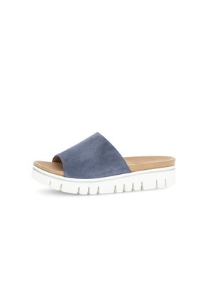 Suede slide sandal in blue, featuring a wide strap, beige insole, and a chunky white sole with grooves for traction.