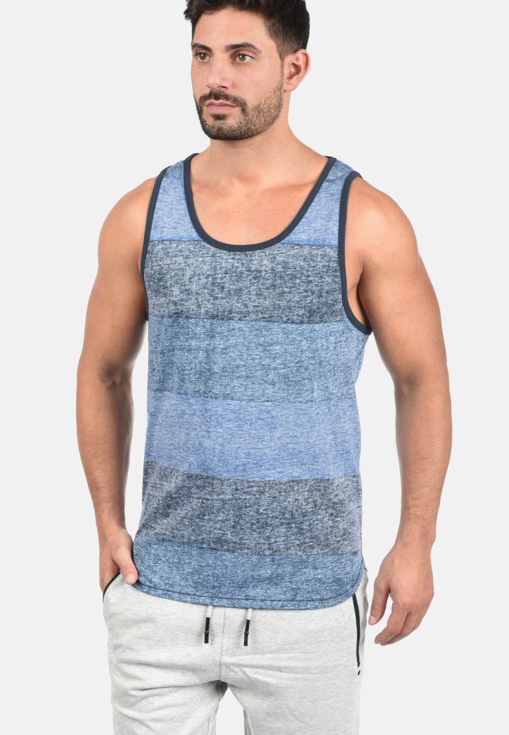 Blå stribet tanktop med varierende nuancer af blå og grå, der har en rund halsudskæring og mørk kant. Fremstillet af et blødt, tekstureret stof.