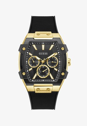 Montre avec un bracelet en caoutchouc noir, dotée d'un boîtier rectangulaire en or et noir. Elle comporte trois sous-cadrans, des accents dorés et des index des heures proéminents.