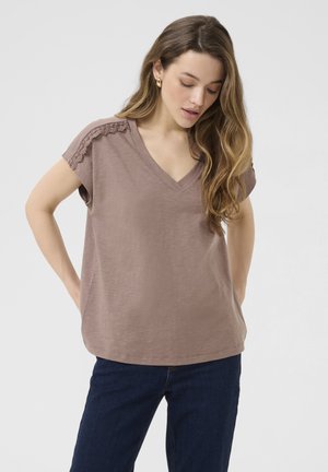 Brun V-hals T-shirt med kortærmer, med blonder og kant på skuldrene. Lavet af blødt stof med en afslappet pasform og lige kant.