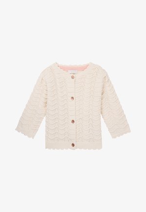 White knitted cardigan with wavy texture, scalloped edges, and a button front. Features three-quarter sleeves and a pink inner lining.