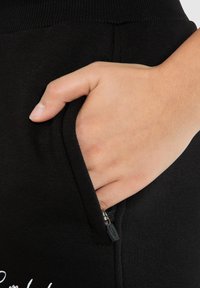 Smilodox Teplákové kalhoty - schwarz