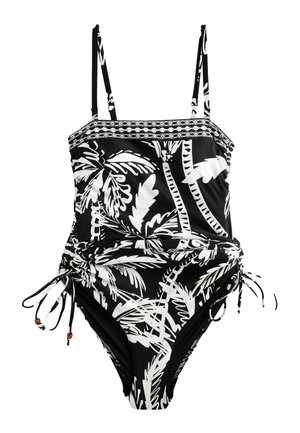 Maillot de bain une pièce noir et blanc avec imprimé de feuilles tropicales, bretelles ajustables et liens latéraux à cordon avec perles en bois.