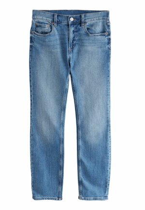 Ljusblå denimjeans med rak benform, fem fickor, bältesöglor och knappstängning fram. Har subtila blekningar och sömnad.