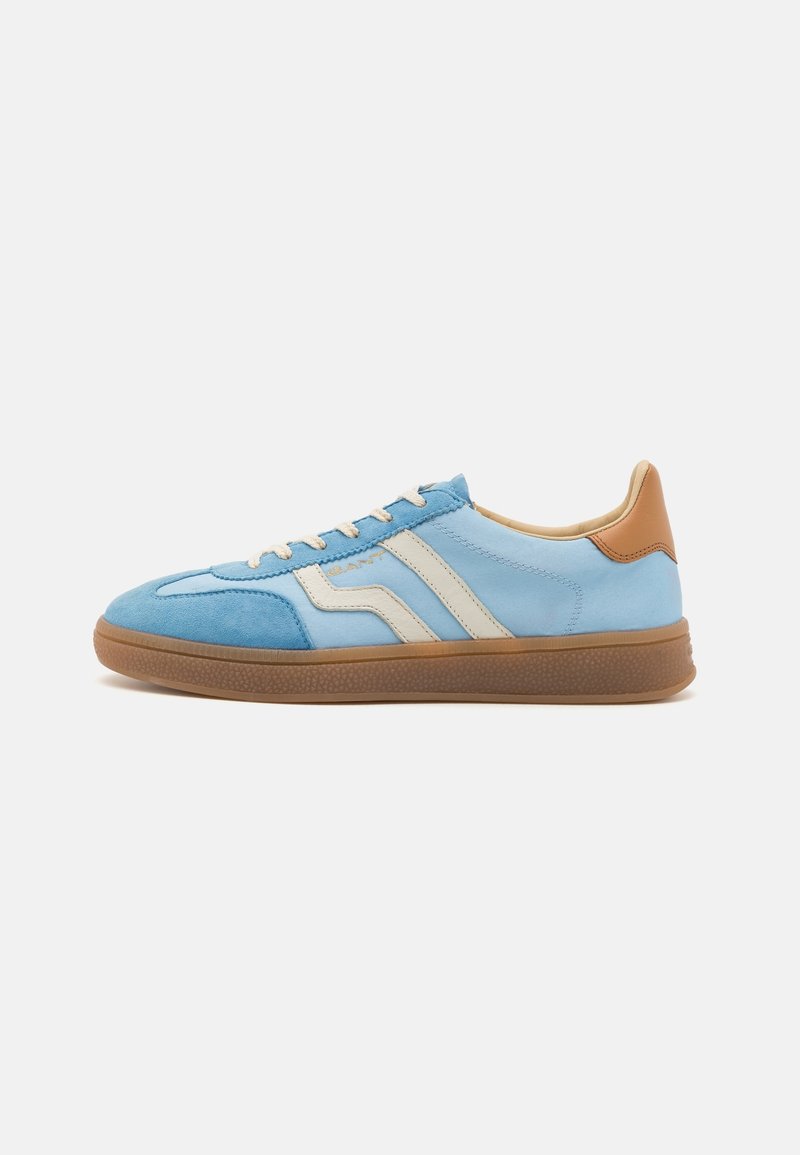 Blue suede sneaker with beige stripes, cream laces, and a tan leather heel accent. Features a textured gum sole and rounded toe design.