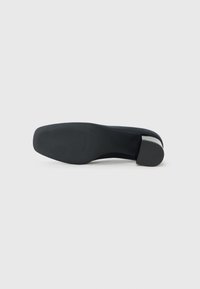 Black high-heeled shoe viewed from the bottom, showcasing a smooth sole and a sculpted heel, set against a plain white background.