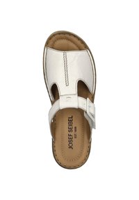 White leather sandal featuring a closed toe, open sides, adjustable buckle strap, and a textured insole with branding details.