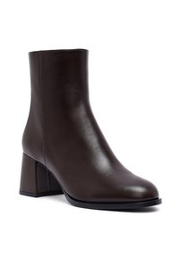 Brown leather ankle boot with a rounded toe, smooth texture, and a low, square block heel. Seam detail along the side.