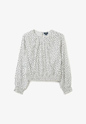 Blusa infantil de manga larga blanca con patrón de puntos irregulares en negro, puños elásticos y dobladillo elástico fruncido.