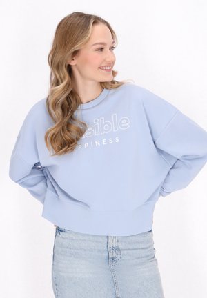 Lichtblauwe sweatshirt met een ronde halslijn en verlaagde schouders. Voorzien van witte tekst "Visible Happiness" op de voorkant, cropped design.