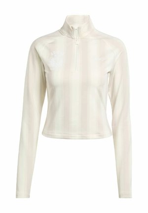 Top bianco a maniche lunghe con zip, dotato di un colletto alto, caratterizzato da sottili righe verticali e dettagli del logo sul petto e sulla manica. Tessuto morbido.