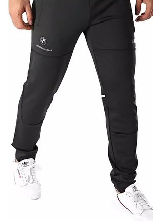 Zwarte sportbroek met twee voorkezen, BMW Motorsport-logo en contrasterende naden. Gemaakt van lichtgewicht, flexibel materiaal.