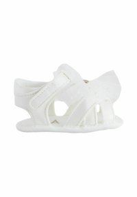 White baby sandals with a breathable design, featuring cutout details, textured fabric, and a decorative sheer bow on the side.