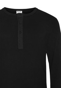 Svart långärmad henley-tröja i ribbad bomull, med rund halsringning, treknappars placket och platta sömmar.
