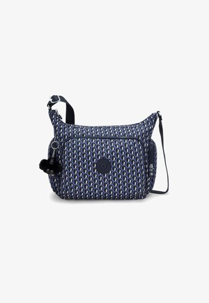 Navy shoulder bag with graphic pattern, zippered compartments, adjustable strap, and pom-pom accessory. Made from durable fabric.
