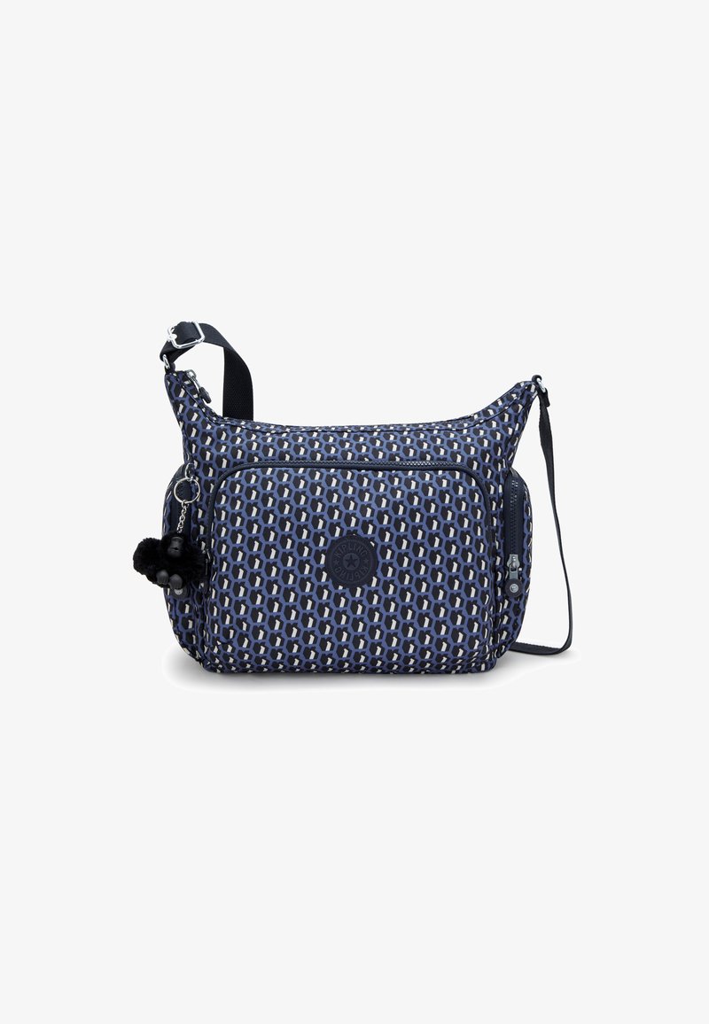 Námořnická taška přes rameno s grafickým vzorem, zipovými kapsami, nastavitelným popruhem a pom-pom doplňkem. Vyrobena z odolného materiálu.
