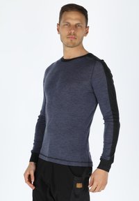 Long-sleeve shirt in dark blue with black accents. Features a round neck, slim fit, and contrasting sleeve detailing. Soft knit texture.