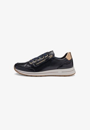 Black leather sneaker with gold zipper and eyelets, matching gold heel accent, white sole, and brown outsole, shown in side profile.