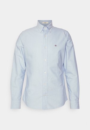Lichtblauwe button-up overhemd met lange mouwen, klassieke kraag en een klein logo geborduurd op de borst. Gemaakt van katoenen stof.