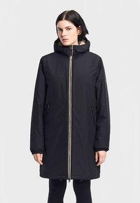 Long black winter coat with a hood, featuring a gold zipper, stand collar, and elastic cuffs. Textured lining visible around the hood.