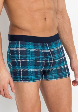 Boxers pour hommes avec une taille en bleu marine. Le tissu présente un motif tartan bleu et bleu canard avec des accents blancs. Design ajusté et extensible.