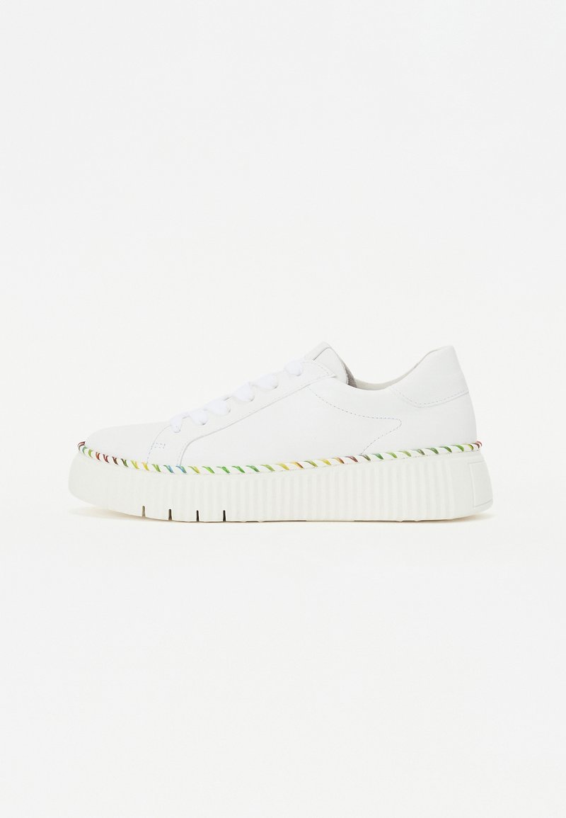 White sneakers with a smooth texture, featuring a raised sole with colorful braided accents around the edge and six white eyelets for laces.