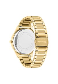 Goudkleurig roestvrijstalen horloge met een schakelarmband, gepolijste afwerking, ronde kast en een heldere achterkant die de mechanische details toont.