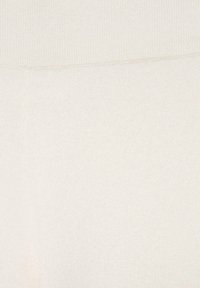 Tessuto a maglia beige chiaro con una superficie liscia; presenta un design semplice e pulito e un colore uniforme in tutta la superficie.