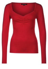 Maglia rossa a maniche lunghe con design aderente, scollatura a V e dettagli arricciati al centro. Realizzata in tessuto a coste.