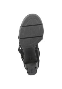 Sole di sandalo nera con superficie in gomma testurizzata, caratterizzata da una forma curvata e linee di battistrada visibili per la presa. Tallone rinforzato per stabilità.