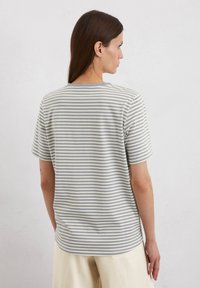 Striped t-shirt in light gray and cream, short sleeves, round neckline, soft cotton material, features horizontal stripes and relaxed fit.