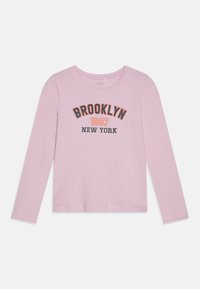 Roze pamučna majica s dugim rukavima s natpisom "BROOKLYN 1987 NEW YORK" ispisanim u crnoj i narančastoj boji na prednjem dijelu. Glatka tekstura, okrugli dekolte.