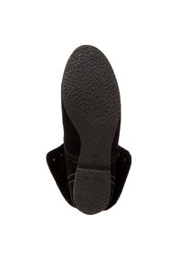 Semelle de chaussure noire avec un motif texturé, taille 36, et le nom de la marque "Tamaris" visible sur la zone du talon.