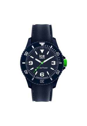 Navy blue solar-powered watch with a textured strap, large white hour markers, and a green accent on the crown. Water-resistant to 10 ATM.