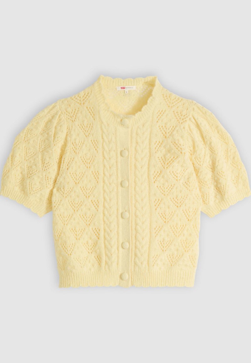 Short-sleeve pale yellow knitted cardigan with cable and diamond patterns, round collar, and fabric-covered buttons down front.