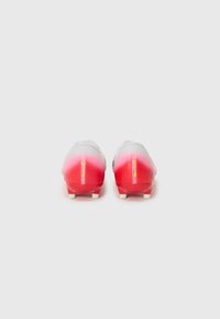 Football boots with a gradient design, transitioning from white to bright red, featuring a smooth texture and contrasting white studs.