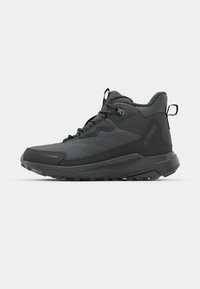 Black high-top outdoor shoes made of synthetic mesh and rubber. Features a textured upper, reinforced toe, and rugged sole for traction.