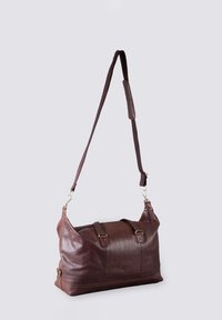 Brown leather duffel bag with adjustable strap, zip closure, and metal hardware accents. Smooth texture with stitch detailing on the base.