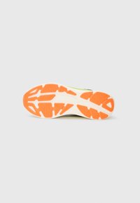 Shoe sole with orange rubber tread sections and white base, shown flat on a light gray background.