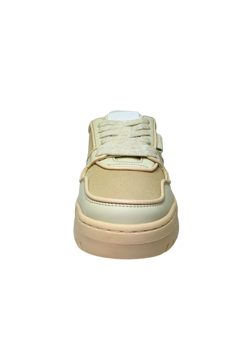 Beige sneaker featuring a smooth leather and textured fabric upper, round toe, flat laces, and a padded collar with a white sole.