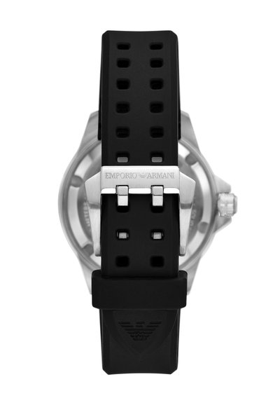 Black rubber watch strap with holes, silver metal buckle engraved "EMPORIO ARMANI," showcasing a curved, textured design behind the strap.