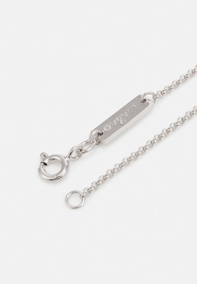 Silver chain necklace featuring a rectangular tag with embossed text, lobster clasp, and small circular links. Smooth metal finish.