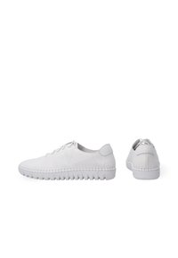 White leather sneakers with perforated design, rounded toe, lace-up front, and textured rubber sole featuring horizontal grooves.