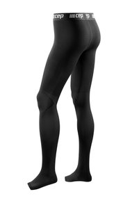 Black compression tights feature a smooth texture, a wide branded waistband, and a contoured fit with knee design for support.