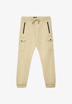 Pantaloni cargo beige con vita elasticizzata, coulisse, due tasche laterali con zip e due tasche laterali con bottone. Polsini aderenti alle caviglie.